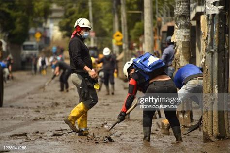 cleaning mud Ecuador|People clean mud from a sidewalk after a flood in northern Quito, .